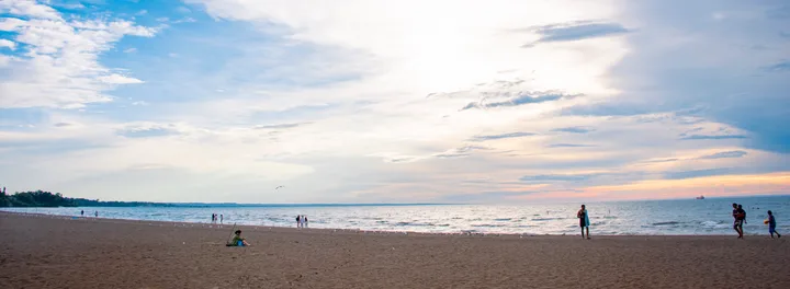 People on the sandy shore at Sunset Beach in St. Catharines.